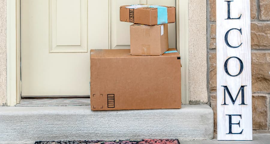 Deliveries on the front porch of a house with a welcome sign in Eau Claire